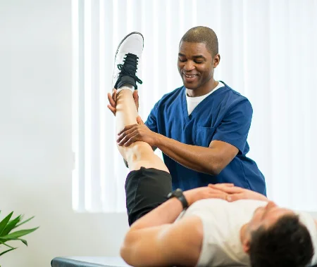Physiotherapist assisting patient